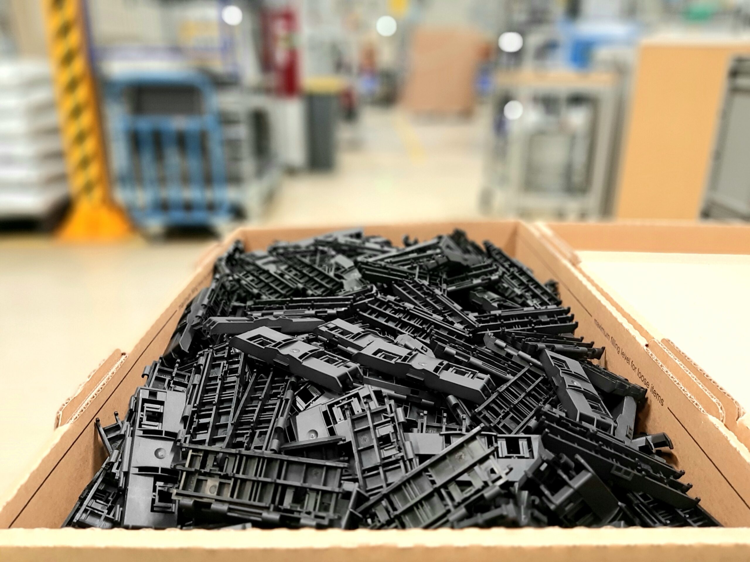 Manufactured plastic components in storage bins